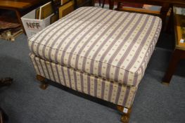 An upholstered foot stool.
