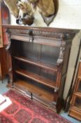 A 17th century style carved oak open bookcase.