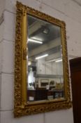 A decorative gilt framed mirror.