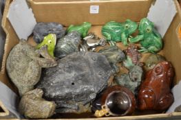 A collection of pottery and other frogs.