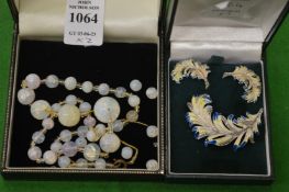 An Opaline bead necklace and a leaf shaped brooch and ear clip set.