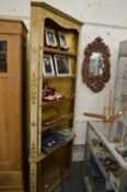 A corner shelving unit with gilded and painted decoration.