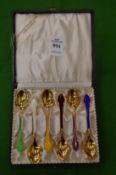 A cased set of six Scandinavian silver gilt and enamel decorated coffee spoons.