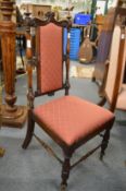 A Victorian rosewood occasional chair with upholstered back and seat.