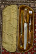 A good cased three piece carving set with antler handles.