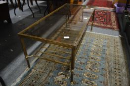 A brass and glass two tier rectangular coffee table.