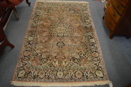 A Persian rug, pink ground with stylised decoration, 180cm x 120cm.