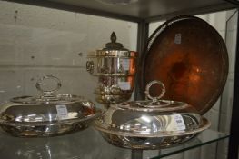 A pair of plated entree dishes, an ice bucket and tray.