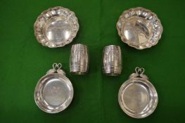 Two pairs of silver dishes and a pair of silver barrel shaped napkin rings.