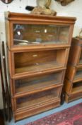 A Globe-Wernicke oak four section bookcase (lacking one pane of glass).
