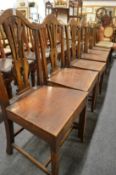 A set of six 19th century elm solid seat dining chairs.