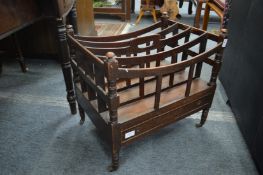 A mahogany four division Canterbury with a drawer to the base.