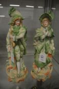 A pair of painted bisque porcelain figures.