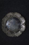 A Stirling silver dish with engraved shaped border.