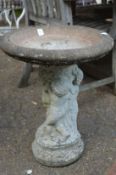 A reconstituted stone bird bath.