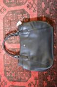 A Laura Ashley black leather handbag.