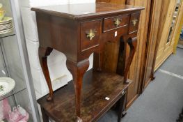 A Georgian style mahogany lowboy.