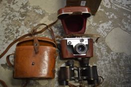 A pair of Bausch and Lomb binoculars, cased and a Corfield Periflex camera with leather case.
