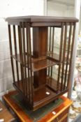 An Edwardian style mahogany revolving bookcase.