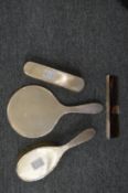 Silver backed four piece dressing table set.