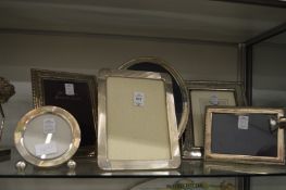 Five silver and silver plated photograph frames.
