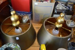 A pair of large decorative metal ceiling lights.