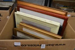 A box of assorted paintings and prints.