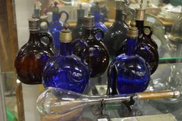 Continental blue and brown glass flagons and a water dipper.