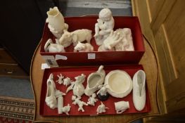 A collection of small white bisque porcelain ornaments and figures.