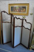 A good carved mahogany four panel dressing screen in the French style of shaped outline with