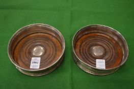 A pair of plated decanter coasters.