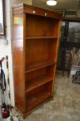 Floor standing yew wood open bookcase.