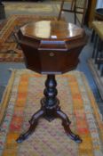 A 19th century rosewood teapoy on tripod base.