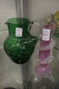 A moulded glass bud vase and a green glass jug.