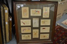 A collection of World War II silk postcards with a photograph of a soldier, framed and glazed and