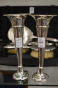 A pair of silver trumpet shaped vases.