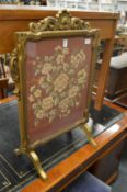 A gilt framed needlework firescreen.