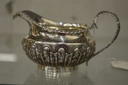A silver cream jug.