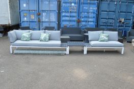 A modern garden lounge suite comprising two stylish sofas, a coffee table together with a green leaf