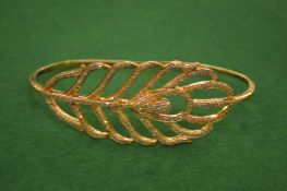 A decorative leaf shaped bangle.