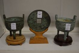 Two Chinese archaic style bronze censers on stands and a similar Bi disc on stand.