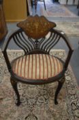 An Edwardian inlaid mahogany armchair.