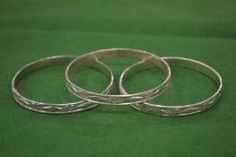 Three engraved silver bangles.
