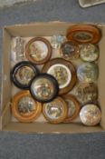 A collection of pot lids, mostly framed.