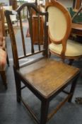 A pair of 19th century oak solid seat dining chairs.