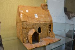 A large salt glazed pottery model of a cottage.