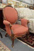A Victorian carved walnut framed open armchair.