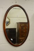 An oak oval wall mirror.