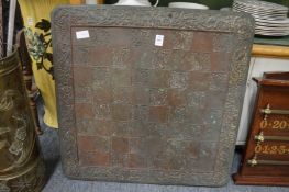 An embossed copper table top.