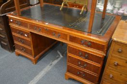 A reproduction yew wood partners desk.
